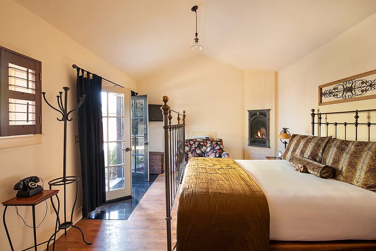 Fireplace and bed of studio luxury hotel room