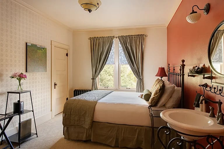 A room at the Chamberlin Inn in Cody Wyoming has a comfortable bed to let you get a restful night's sleep in this historic boutique hotel.