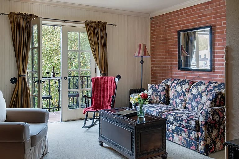 The sitting area in one of the rooms at the historic Chamberlin Inn with French doors that open to a small patio that overlooks the garden courtyard.