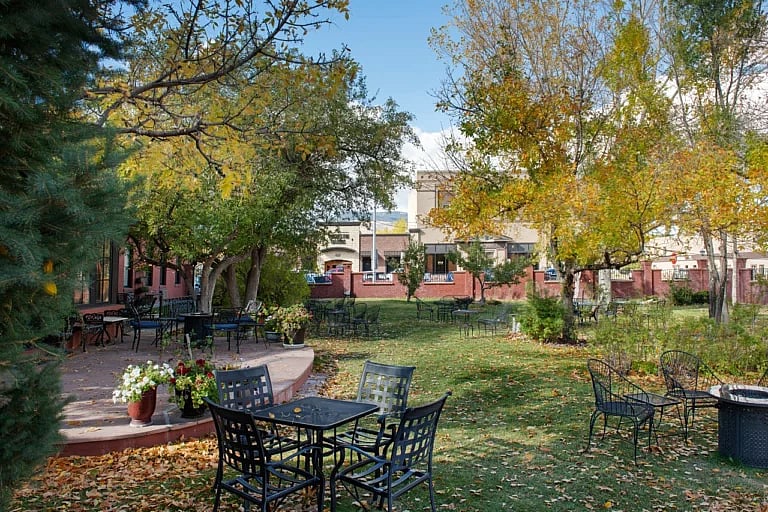 Outdoor seating in the relaxing courtyard at the Chamberlin Inn in Cody Wyoming - an exclusive, luxury hotel.