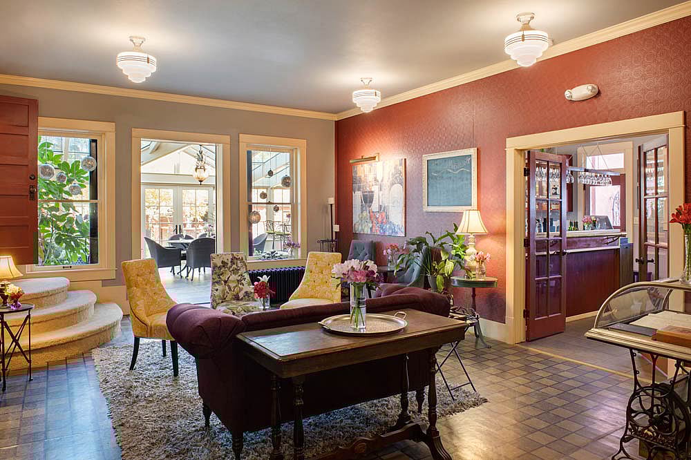 The Chamberlin Inn, a historic boutique hotel in Cody Wyoming has a bar, cocktail lounge and glass conservatory with an open plan that makes it a favorite of locals and visitors alike. thumbnail