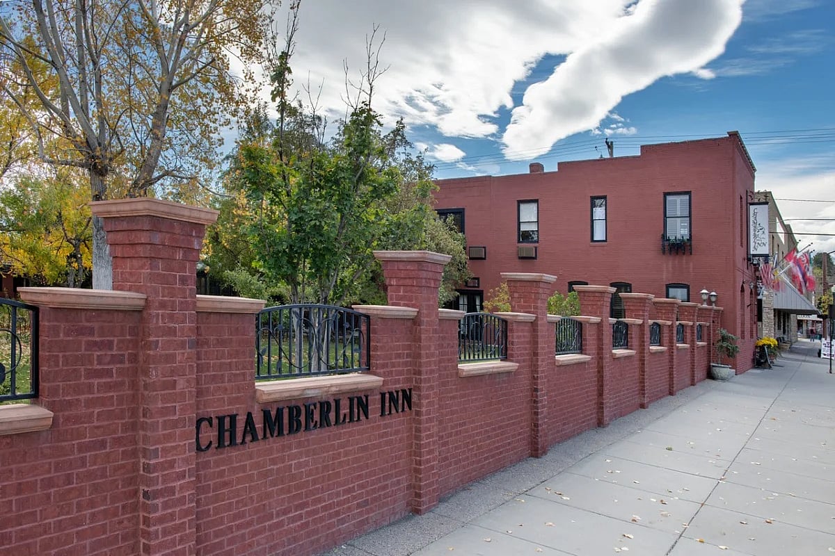 The courtyard side of the Chamberlin Inn provides a low brick wall to create an enchanting, private space for people to meet for cocktails and music in Cody, Wyoming.