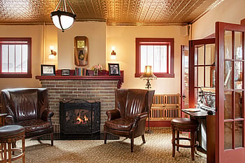 A cozy fire greets visitors at the entrance to the Chamberlin Inn, a luxury boutique hotel in the heart of downtown Cody, Wyoming where the original antique switchboard also resides.