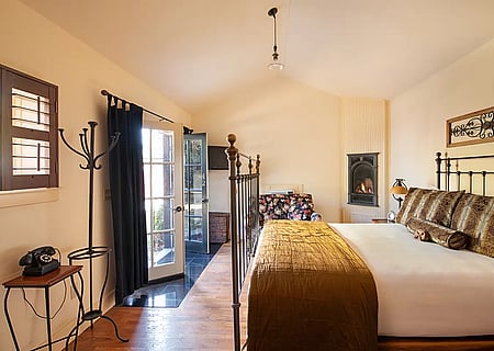 Fireplace and bed of studio luxury hotel room