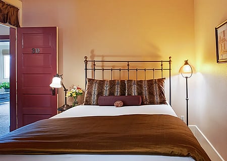 A comfortable bed awaits guests visiting Cody, Wyoming at the historic Chamberlin Inn.