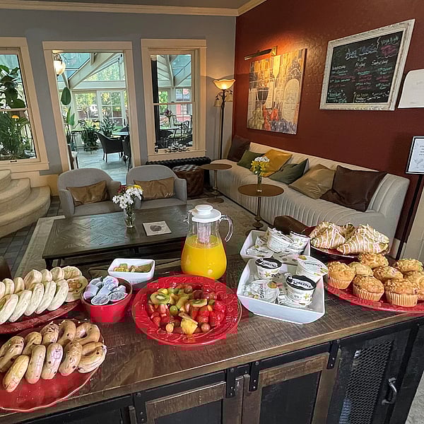 Bagels, fruit, yogurt, muffins, and juice set out as a continental breakfast at the Chamberlin Inn