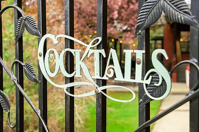 Metal sign that says "Cocktails" at the entrance to the Chamberlin Inn bar