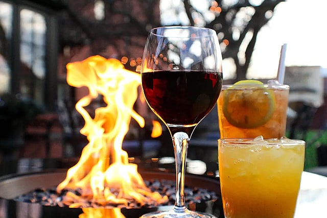Cocktails from the Chamberlin Inn bar with fire in the background