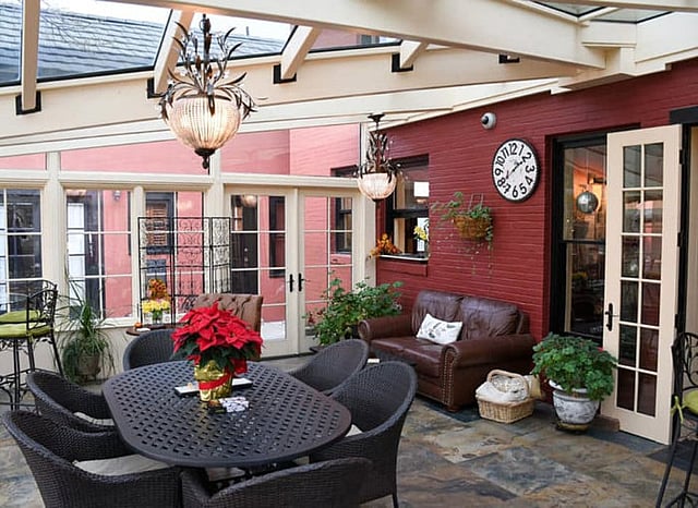 The conservatory at the historic Chamberlin Inn hotel in Cody Wyoming provides an elegant space to comfortably meet for cocktails.