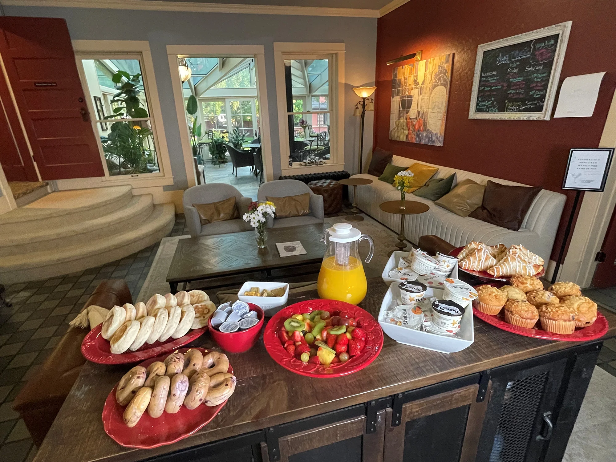Bagels, fruit, yogurt, muffins, and juice set out as a continental breakfast at the Chamberlin Inn